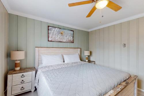 a bedroom with a bed and a ceiling fan at Straney #3-Sea Renity in Ocean City