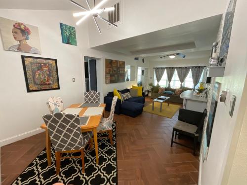 a living room with a table and chairs and a couch at Spacious Ranch 7 min to beach/ airport Pet friend in Melbourne
