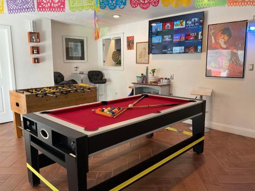 a billiard table in a room with a pool table at Spacious Ranch 7 min to beach/ airport Pet friend in Melbourne