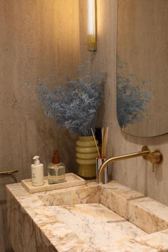 a bathroom counter with a sink and a mirror at Caleda Rooms - Boutique Stay in Dubrovnik Center in Dubrovnik