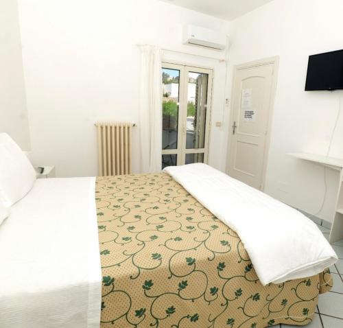 Postel nebo postele na pokoji v ubytování Hotel Il Vascello