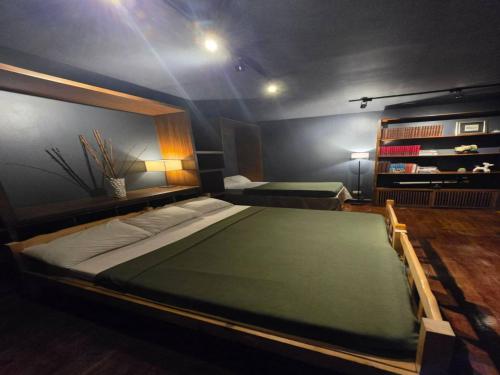 a bedroom with a large bed in a room at Family Room - Casa Encantada Executive 1 in Tuding