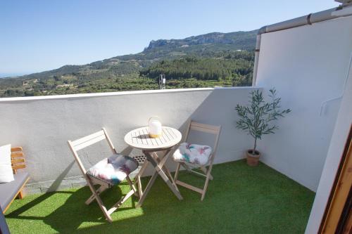 a small balcony with a table and two chairs at El Balcón Guadalest in El Castell de Guadalest