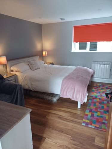 a bedroom with a large bed and a window at The Garden Lodge in Cappoquin