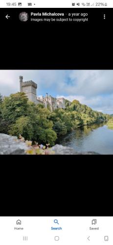 a screenshot of a picture of a river with a castle at The Garden Lodge in Cappoquin