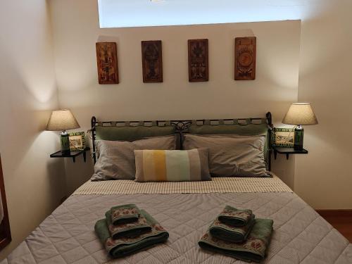 a bedroom with a bed with two towels on it at Casa dei Cedri in Sommacampagna