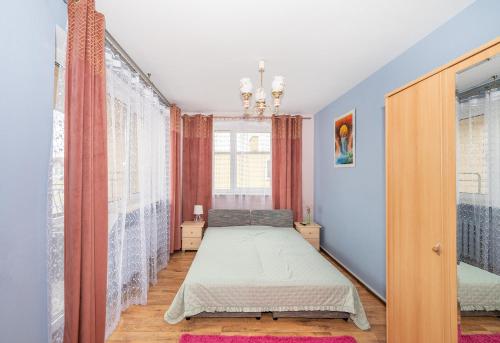 a bedroom with a bed and a window at Noclegi Paradise in Darłówko