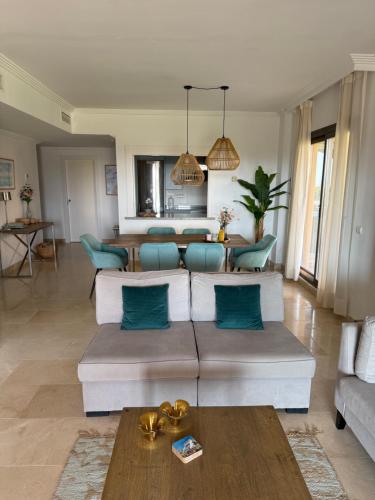 a living room with a couch and a table at Wonderful 3-bedroom apartment with garden and amazing views Hacienda Senorio Cifuentes Marbella in Benahavís