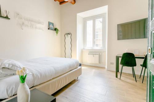 a white bedroom with a bed and a desk at Home Sweet Rome Lucina in Rome