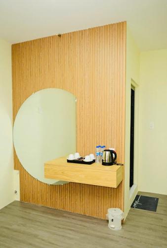 a room with a wooden wall with a counter and a mirror at Homestay The Sunset in Phan Thiet