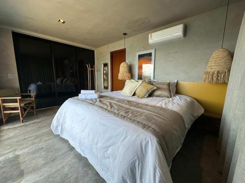 a bedroom with a large bed in a room at Bangalo do Sol in CÃ¡ssia