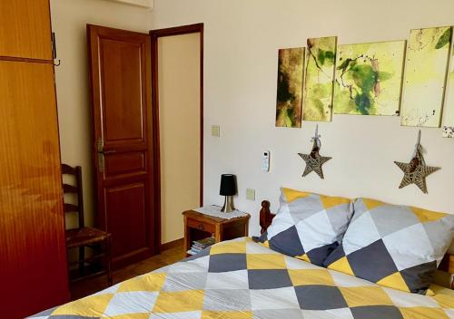 a bedroom with a bed and stars on the wall at Windmill Cottage of Monpazier in Capdrot