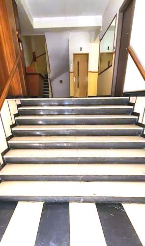 a group of stairs in an empty building at Condo, Hilton & Caravel area, Athens Center in Athens