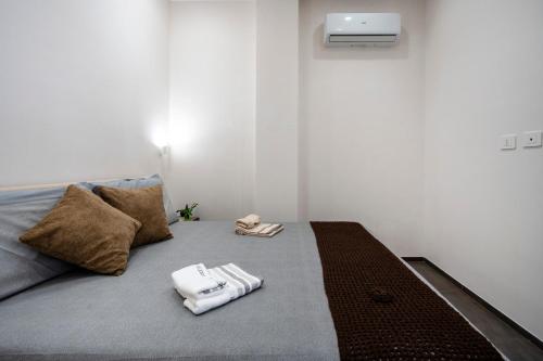 a bedroom with a bed with two towels on it at Tra Mare & Trulli 2 in Fasano
