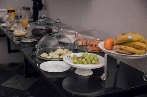 a buffet with plates of food on a table at Pousada Marias Foz - Centro in Foz do Iguaçu
