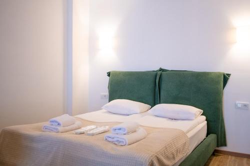 a bed with towels on top of it at Go-Gudauri The Atrium Residence in Gudauri
