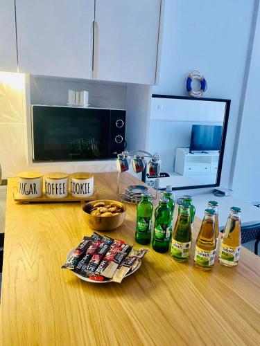 a group of soda bottles on a wooden table at Caesar Resort Apartments Marcellus 51 in Iskele