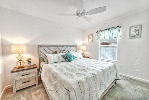 a bedroom with a bed and a ceiling fan at King Sized Comfort in The Village of Deluna in The Villages