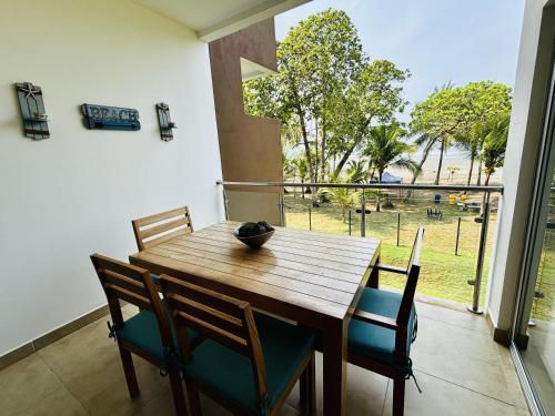 a dining room with a wooden table and chairs at Spacious Beachfront Condo 3202 | Playa Bejuco + Pool + Direct Beach Access in Bejuco