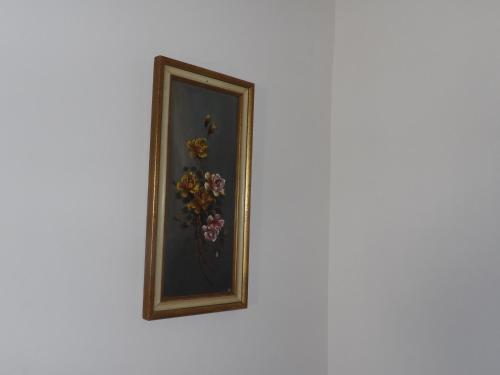a framed picture of flowers on a wall at Poppys in Céret