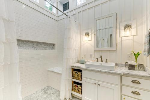 a white bathroom with a sink and a shower at Highlands Vacation Rental - Walk to Main St! in Highlands