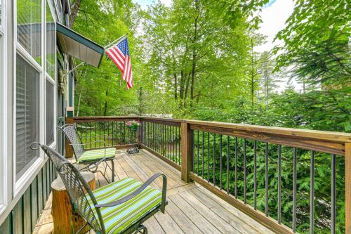 a porch with two chairs and an american flag at Highlands Vacation Rental - Walk to Main St! in Highlands