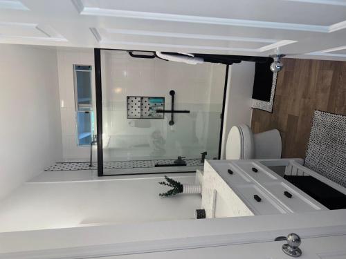 a bathroom with a glass shower and a sink at Pines182 in Kailua-Kona