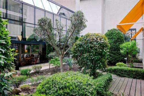 a garden in front of a building at Best Western Crequi Lyon Part Dieu in Lyon