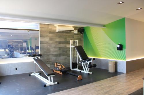 a gym with a green wall and a treadmill at Holiday Inn Mexico Dali Airport by IHG in Mexico City