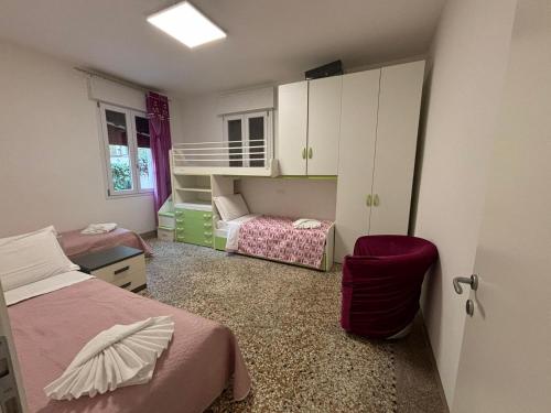 a bedroom with two beds and a bunk bed at Venice Station Guest House in Mestre