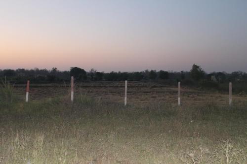 a fence in the middle of a field at AK family Home Stay in Gaushala