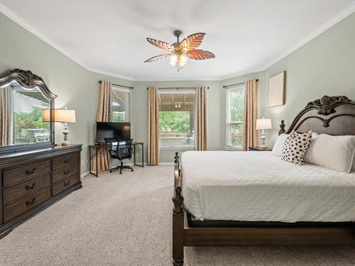 a bedroom with a large bed and a dresser at The Sapphire Sanctuary with Pool in Allen