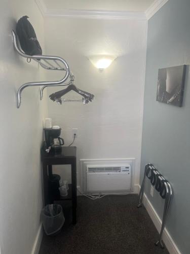 a room with a heater and a phone on a wall at El Rancho Motel in Williams