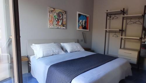 a bedroom with a large bed with white sheets and pillows at Borgo Chimento in San Nicola Arcella