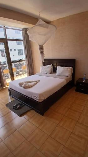 a bedroom with a bed with a lamp on it at Dagmaros Guest House in Bahir Dar