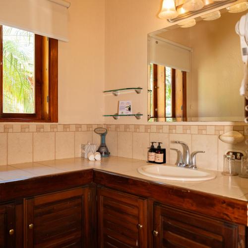 a bathroom with a sink and a mirror at CC Beach Front Papagayo All Inclusive in Papagayo, Guanacaste