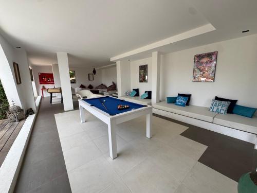 a living room with a pool table and couches at Villa Hirondelles 35 in Cavalaire-sur-Mer