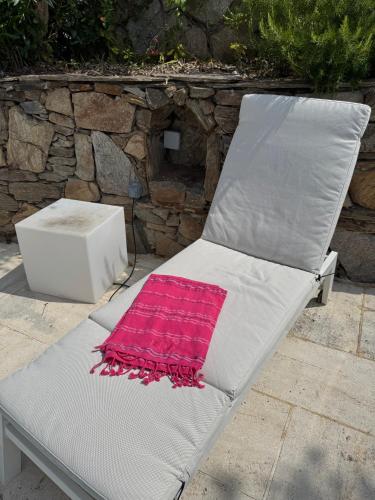 a white chair with a pink blanket on it at Villa Hirondelles 35 in Cavalaire-sur-Mer