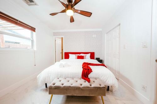 a white bedroom with a bed and a ceiling fan at Luxe 4 BR Heated Pool - Hardrock - Stadium - Beach in Hollywood