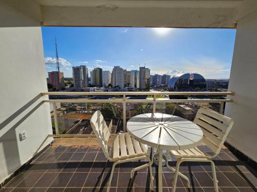 a table and chairs on a balcony with a view of a city at ABC Apart Hotel in Brasilia