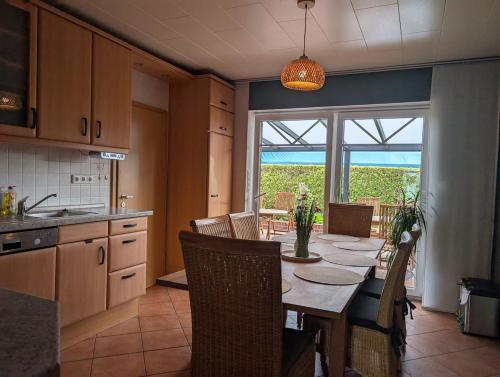 a kitchen and dining room with a table and chairs at Ferienhaus Lina in Südbrookmerland