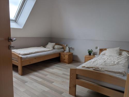 a bedroom with two beds and a window at Ferienhaus Lina in Südbrookmerland