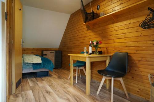 a room with a table and chairs and a bed at Penzion a drevenica pri Hati in Terchová