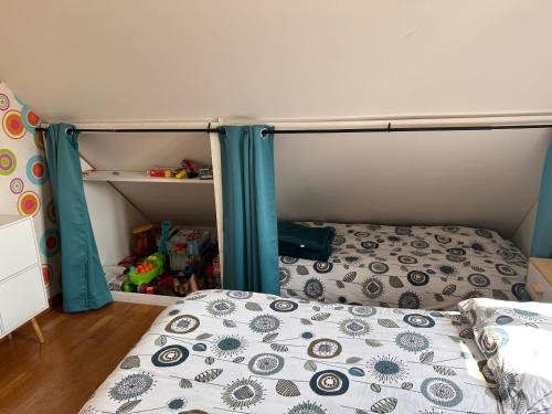 a bedroom with a bunk bed with blue posts at La maison de Lilylou in Villars-Saint-Georges