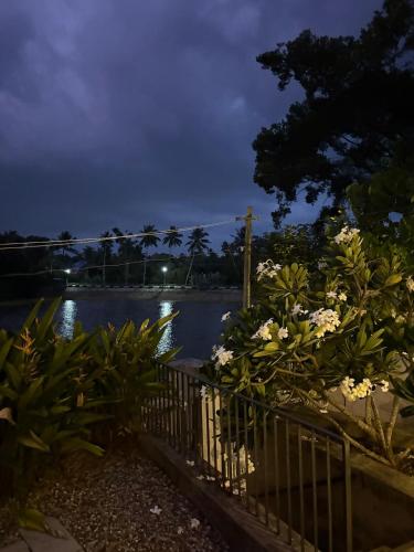 a view of a body of water at night at Ripples Cove Retreat - Your dream Lakeside getaway in Paravūr