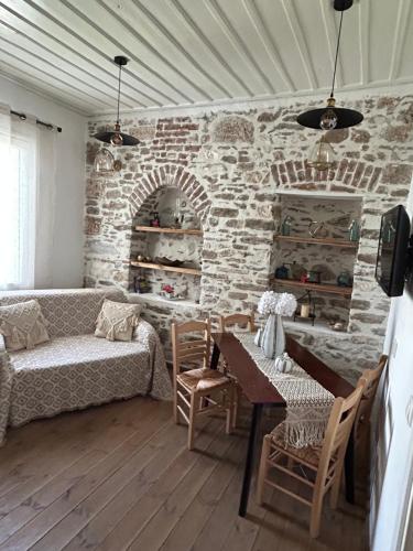 a living room with a couch and a table at Filipa Gardens in Limenas