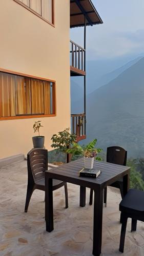 a wooden table and chairs in a patio at Ecoterra Inka Lodge in Santa Ana