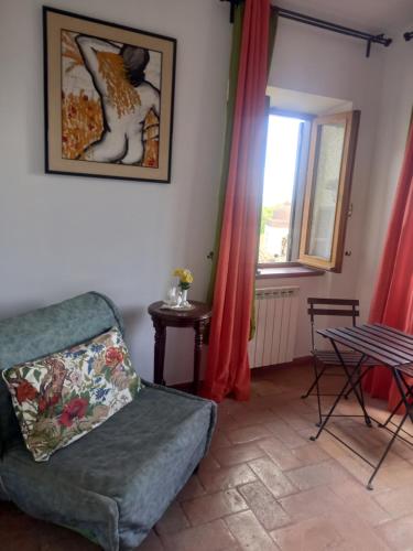a living room with a couch and a window at Autenticum Agriturismo Tolfa in Tolfa