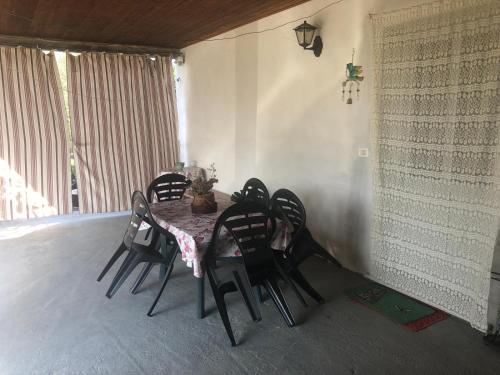 a dining room with a table and black chairs at Fermete chì! in Sarzana