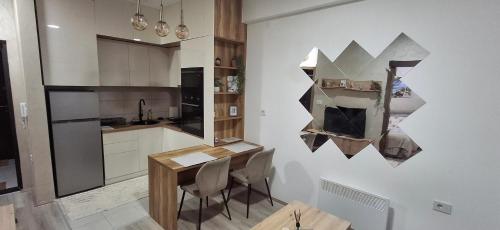 a kitchen with a table and chairs in a room at Apartmani Marjanovic in Jagodina